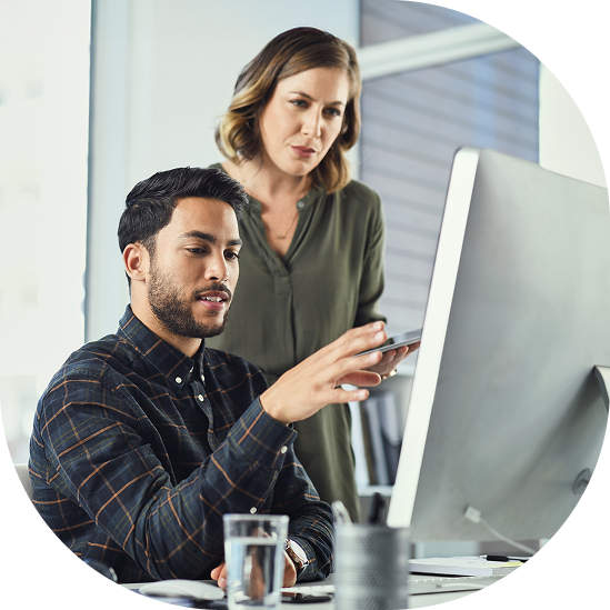 Collaborative UAT Testing for Clinical Trials Two clinical trial professionals collaborating at computer workstation during UAT testing process